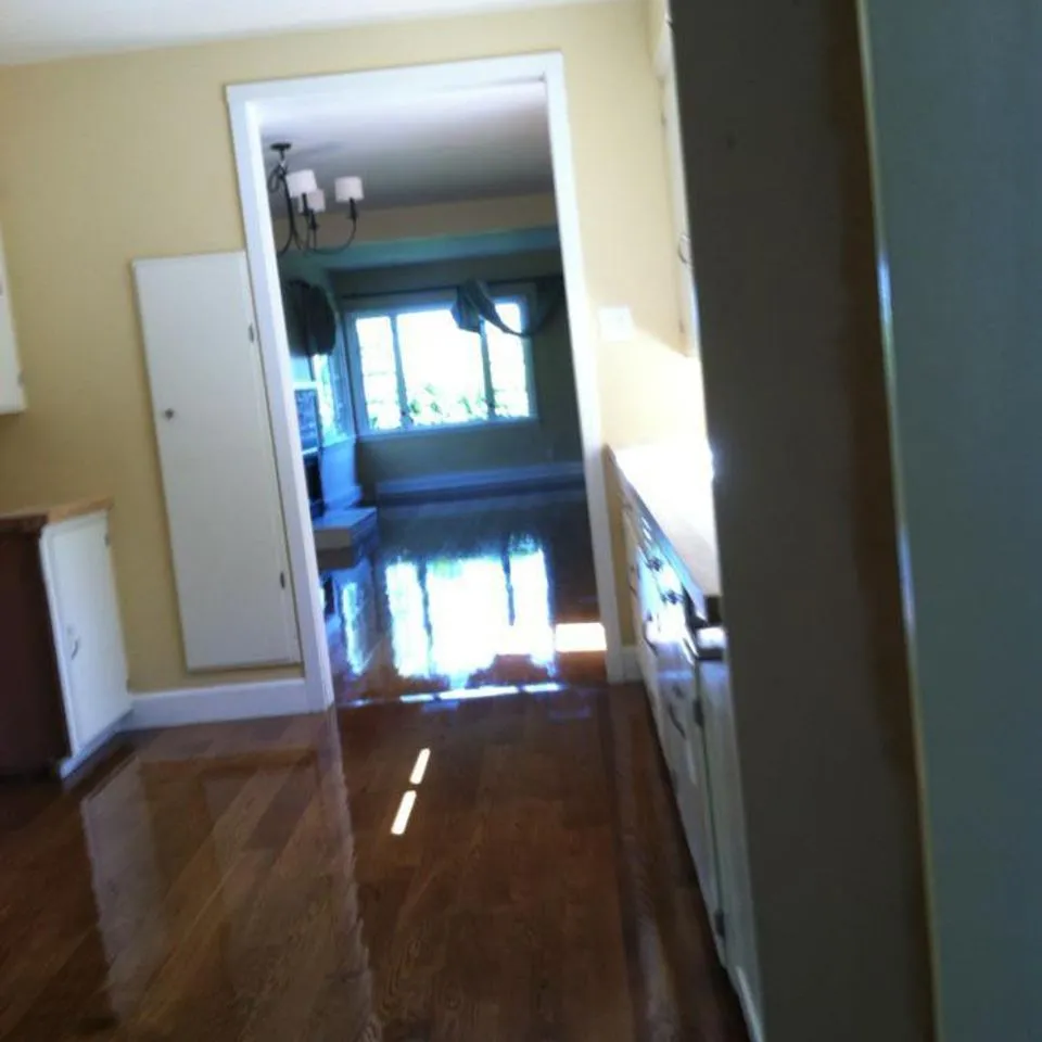 A brightly lit room with polished hardwood flooring, showcasing the craftsmanship of Navarro Flooring in Rohnert Park.
