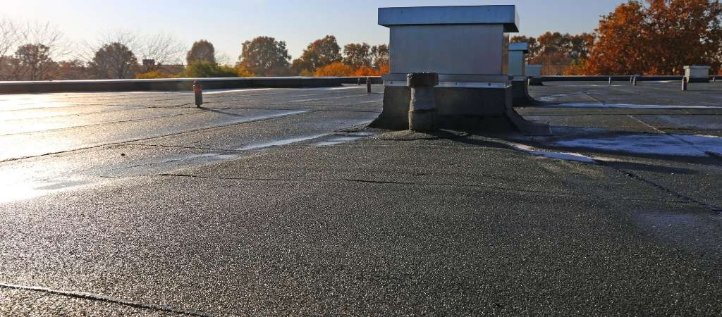 Flat rooftop with vents and chimneys, showcasing professional work by New Era Roofing, LLC in Sacramento.