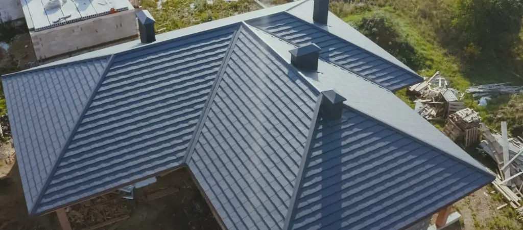 Overhead view of a newly installed dark shingle roof with multiple peaks by New Era Roofing, LLC in Sacramento.