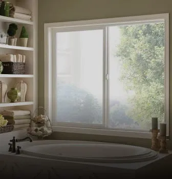 A serene bathroom with a large sliding window by Northwest Exteriors, showcasing an outdoor view of greenery, located in Santa Rosa.