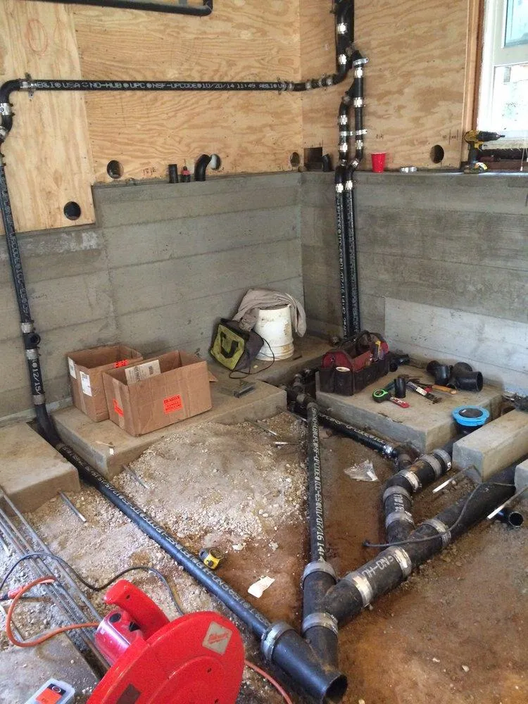 Image of a plumbing installation in progress with pipes and tools in a construction setting by One Source Plumbing and Rooter, Inc. in San Francisco.