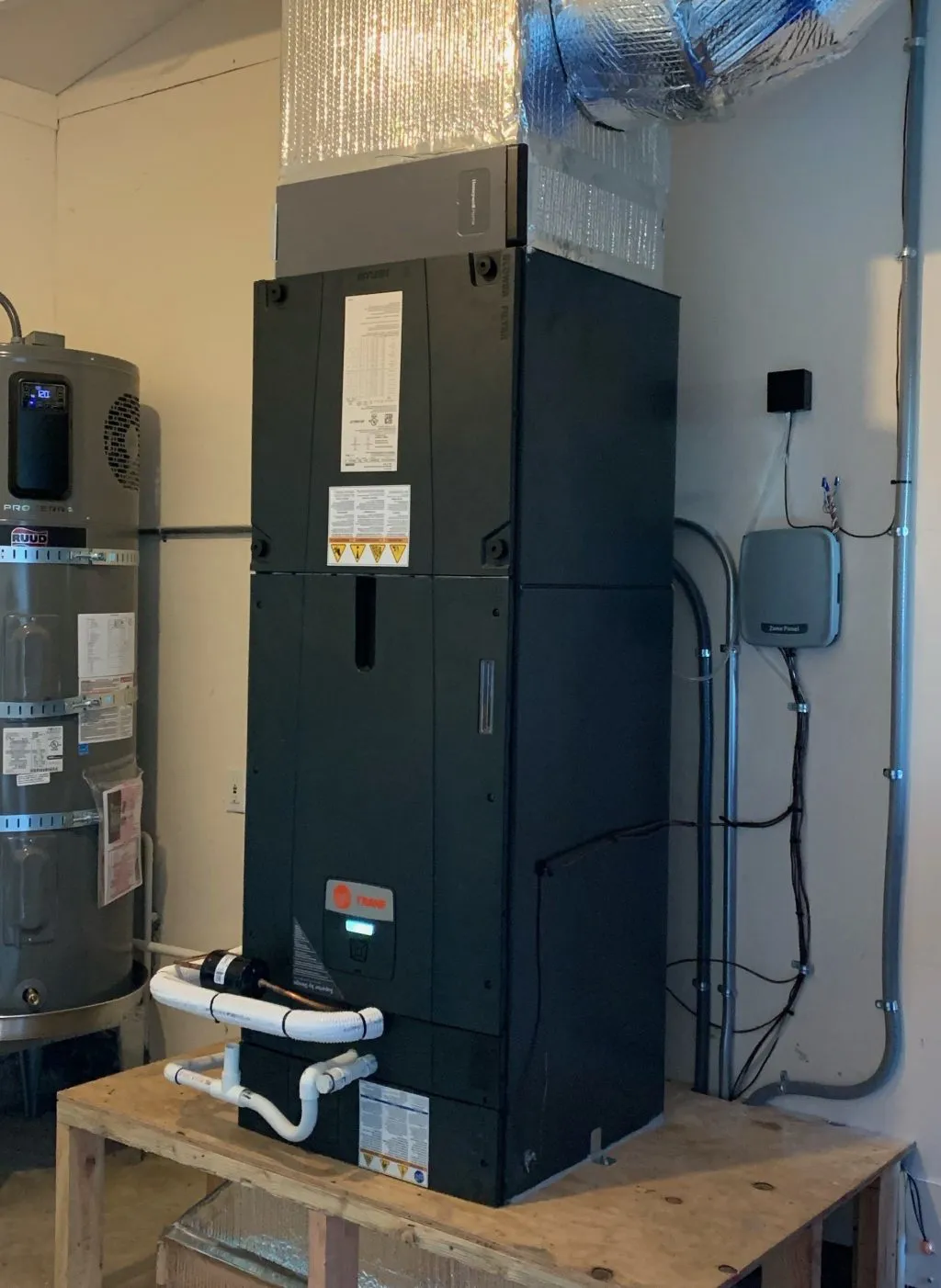 A sophisticated HVAC system installed in a utility room, alongside a water heater, showcasing energy-efficient technology provided by Ongaro & Sons in Santa Rosa.