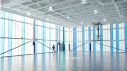 Interior view of a modern sports facility with a sleek, bright design featuring large windows and a high ceiling, completed by Pacific Exterior in Santa Cruz.