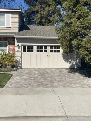 A well-maintained garage door on a suburban home, featuring design elements installed by Palms Garage Doors, San Jose.