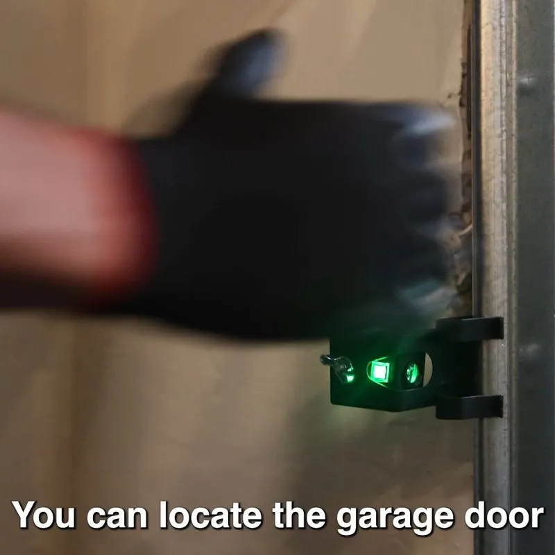 A gloved hand adjusting a sensor light on a garage door track, enhancing alignment for Palms Garage Doors in San Jose.