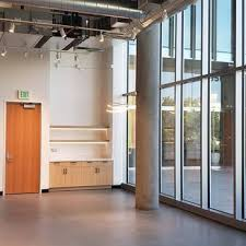 Interior of a modern room with wooden cabinets and large windows, designed by Peninsula Design and Construction in Hayward.