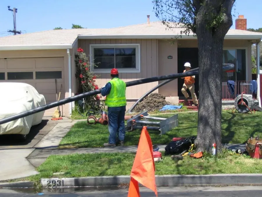 "Pipe Spy Inc. workers installing a pipeline in front of a house in Berkeley, focusing on trenchless technology."