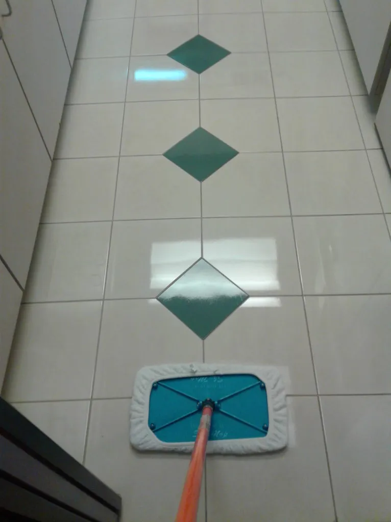 A perfectly cleaned tile floor in Dublin with a mop from Precision Cleaning Services in use.
