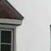 Image of a house exterior featuring part of a window and white wall, representing the quality and craftsmanship of Precision Door Services of the Bay Area in Hayward.