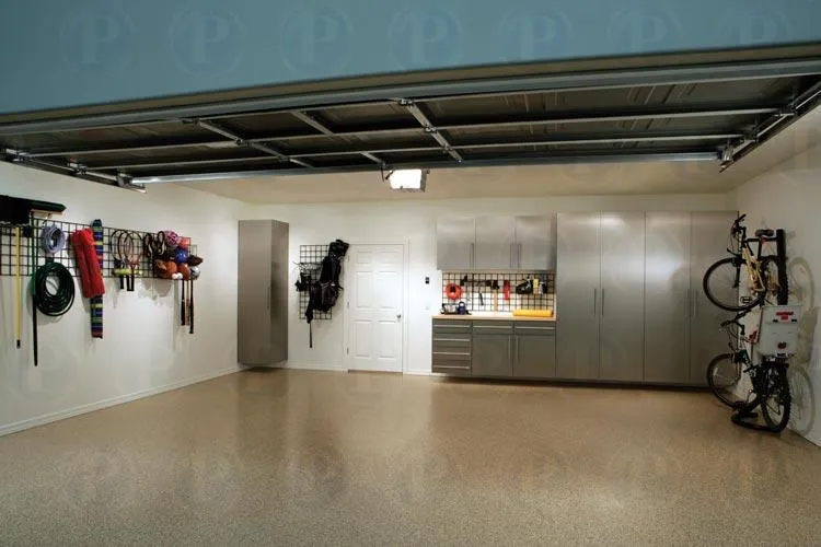 A clean and well-organized garage with storage cabinets, wall-mounted racks, and hanging bicycles, showcasing PremierGarage's design in San Mateo.