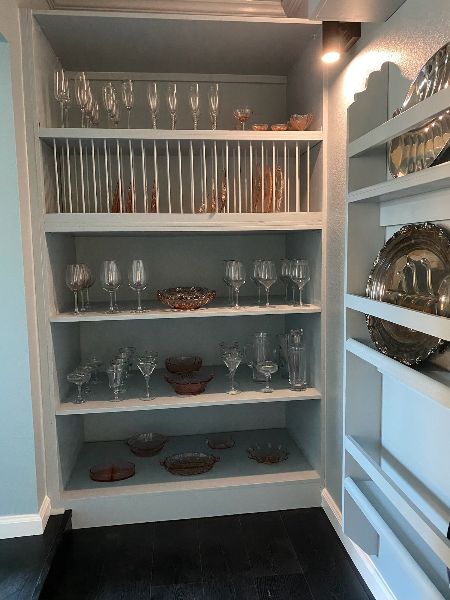 Built-in shelving unit displayed in a Santa Rosa home by Prime Level Construction, featuring glassware and decorative items.