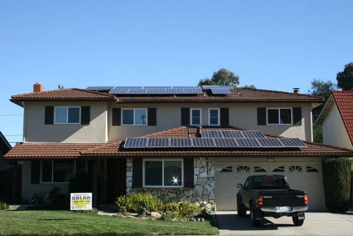 A two-story house in Citrus Heights featuring multiple solar panels on the roof, installed by Quality First Home Improvement, Inc., with a truck parked in the driveway.