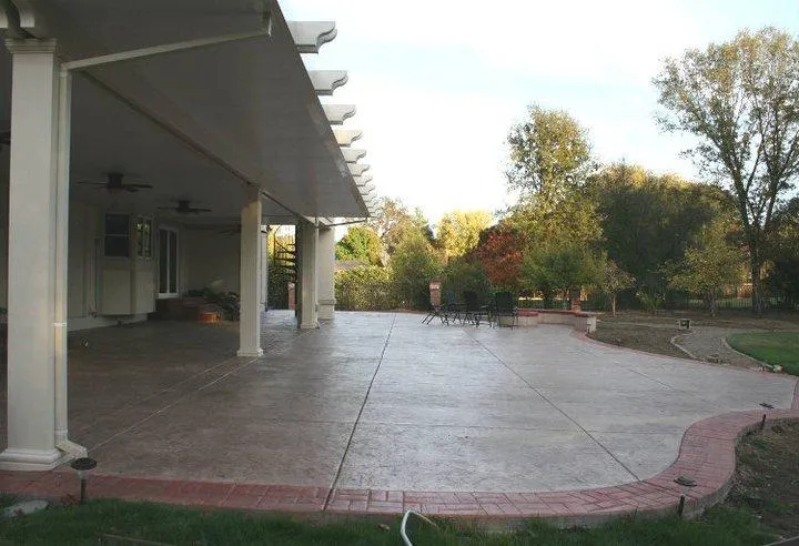 A spacious patio with a covered area and furniture, surrounded by greenery, highlighting Quality First Home Improvement, Inc.'s work in Citrus Heights.