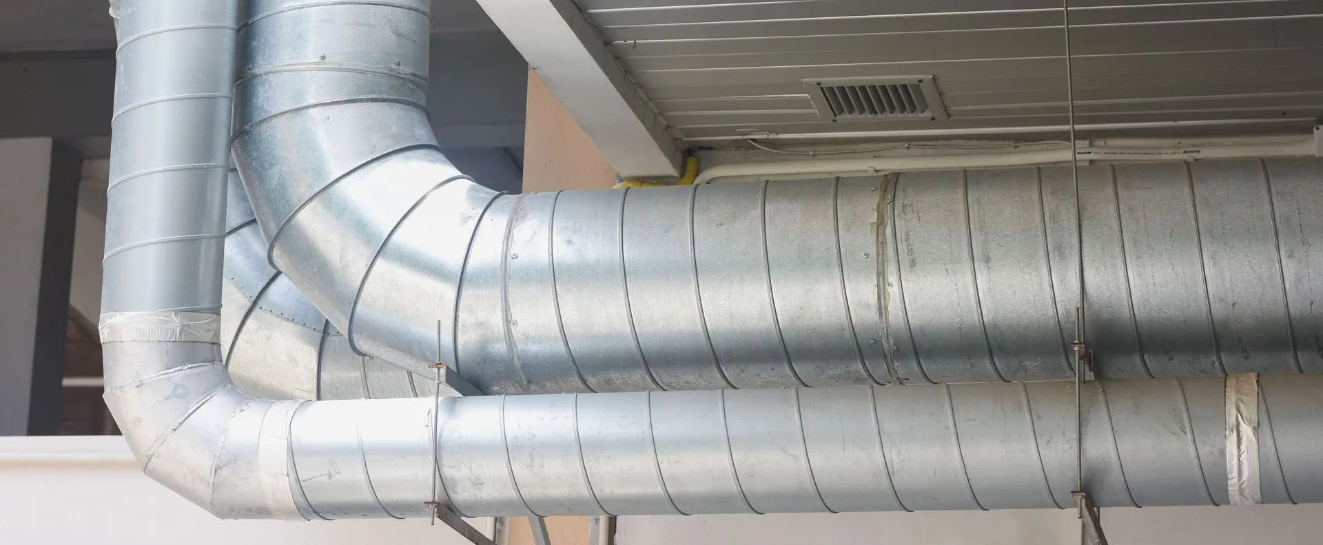 Industrial metal ductwork installed by Qualtech Heating & Cooling in Danville, showcasing efficient air handling design.