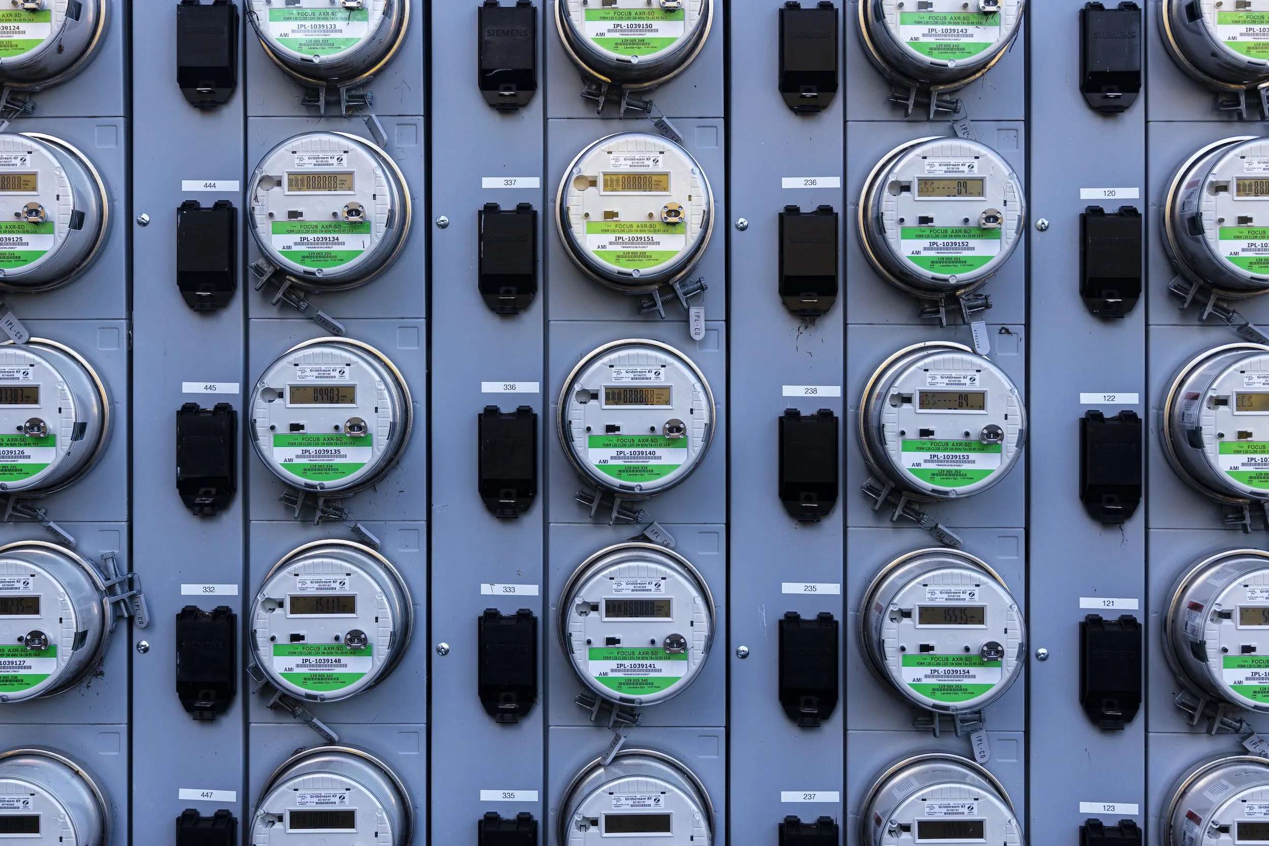 A grid of multiple electrical meters mounted on a wall, used for measuring electricity consumption, showcasing REFCorp’s precision technology in Daly City.