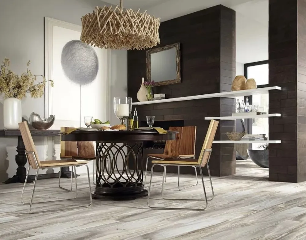 Modern dining room with a round table and wood chairs, featuring stylish decor and light-toned wood flooring.