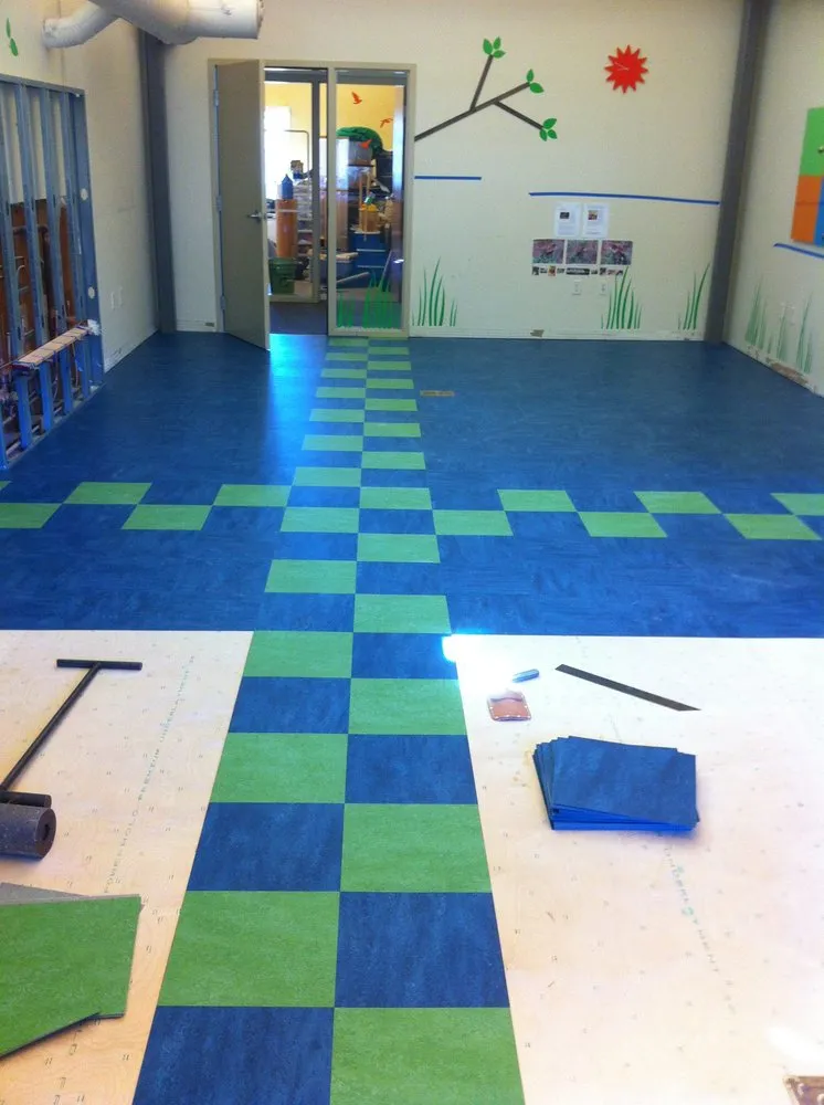 Room with blue and green checkered flooring being installed, showcasing tools and materials from Rafael Floors, Abbey Carpet Center in San Rafael.