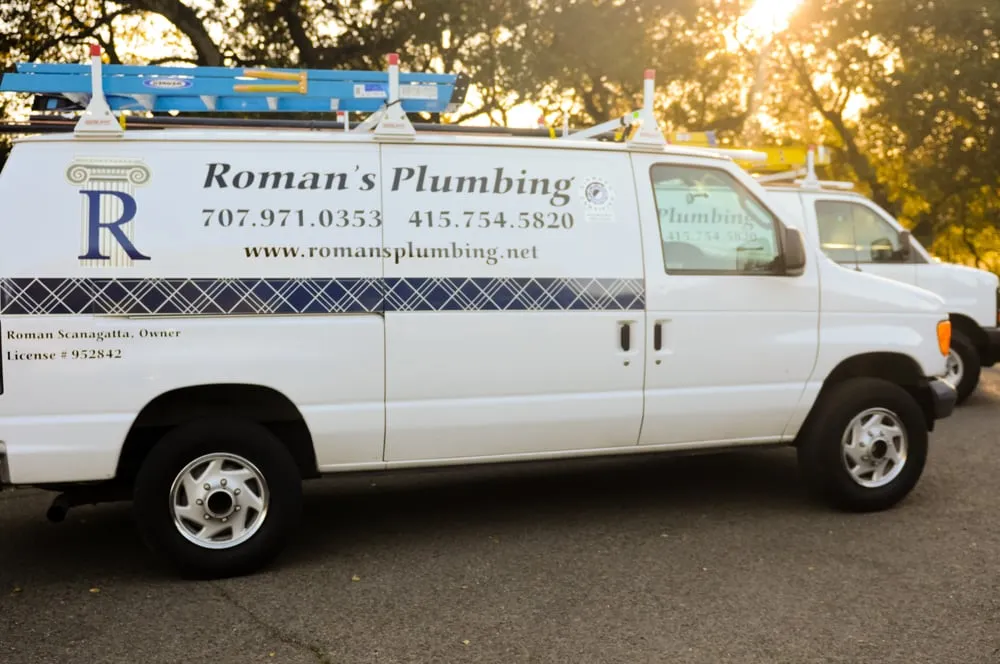 A Roman's Plumbing, Inc. service van parked on a road in Petaluma, displaying the company's logo, contact information, and equipment.