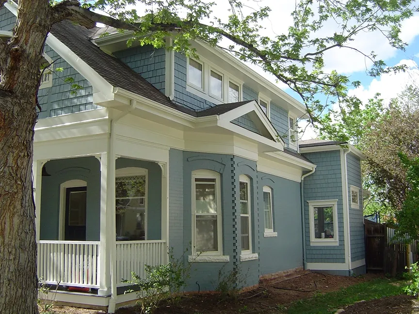 A beautifully painted blue house with white trim, showcasing the detailed exterior work by S & S Painting and Coatings, Inc. in Castro Valley.