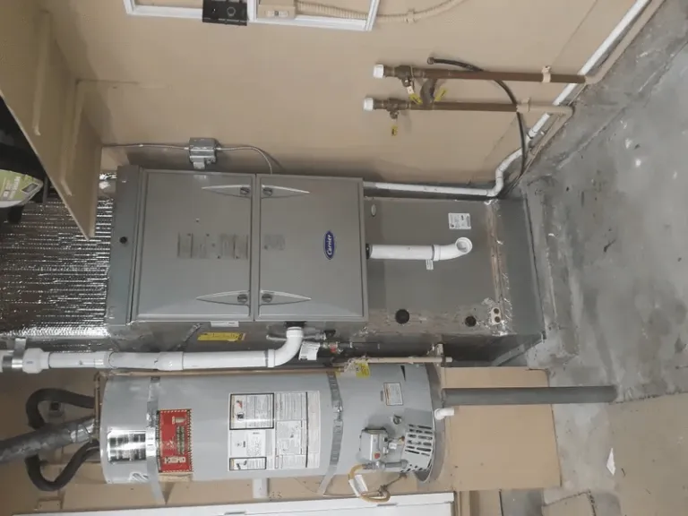 Image of a heating and cooling system installation showcasing a furnace and water heater setup in a SanJose residence.