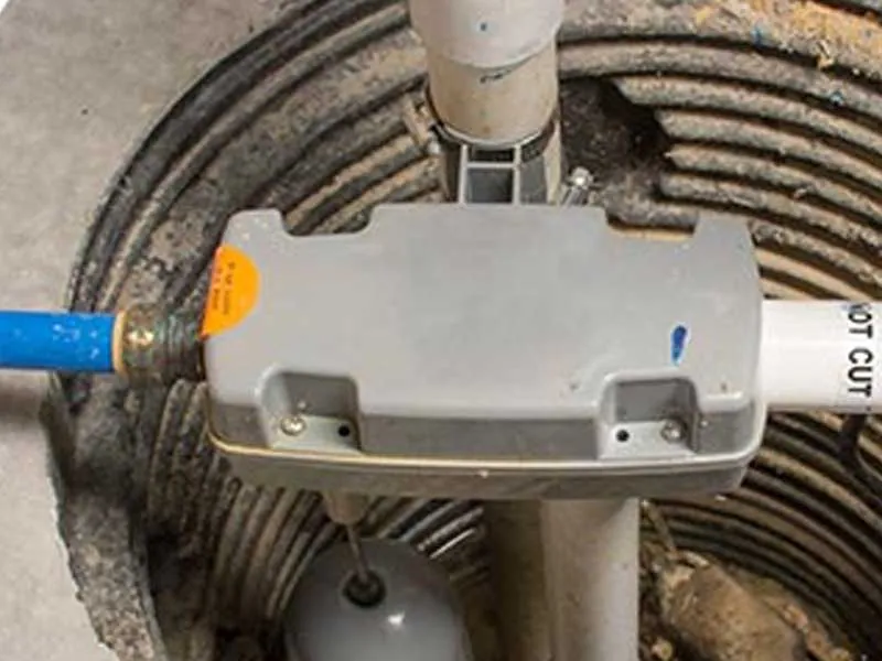 Close-up image of a sump pump system with visible pipes and wiring components installed by San Jose Plumbing, Inc. in San Jose.