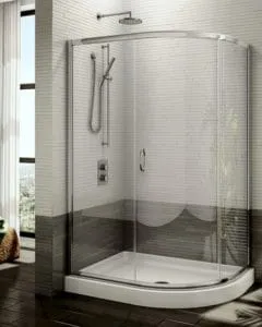 A modern, elegantly designed glass shower enclosure featuring a curved sliding door, chrome fixtures, and a luxurious rain showerhead, produced by Schicker Luxury Shower Doors, Inc. in Concord.