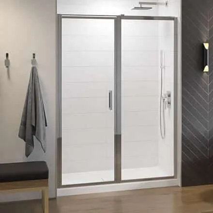 Modern frameless glass shower door with chrome accents by Schicker Luxury Shower Doors, Inc., showcasing a sleek design in a contemporary bathroom setting in Concord.