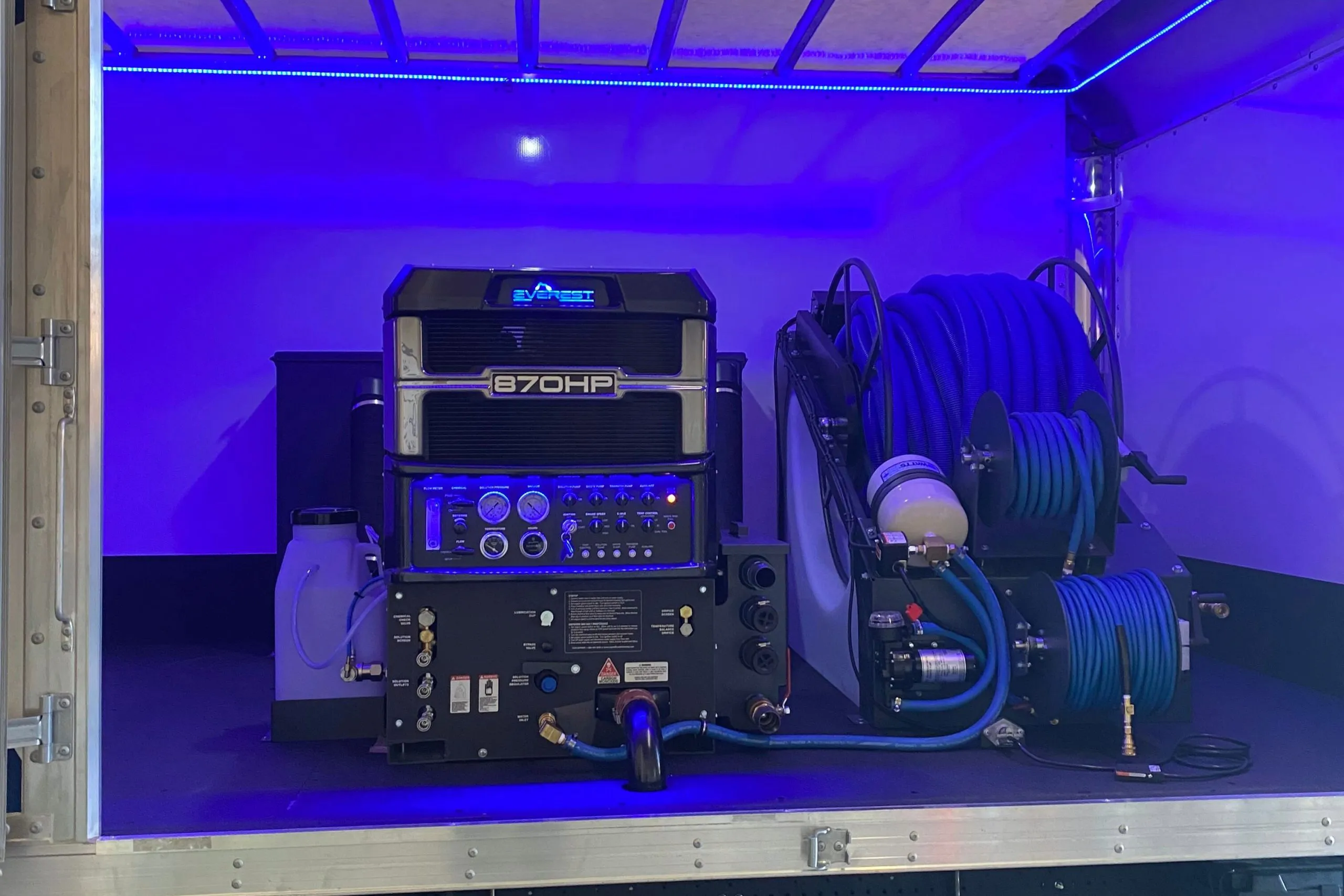 Image of a high-powered steam cleaning machine with hoses and controls, used by Scotty Steam Clean in Santa Rosa, illuminated by blue lighting.