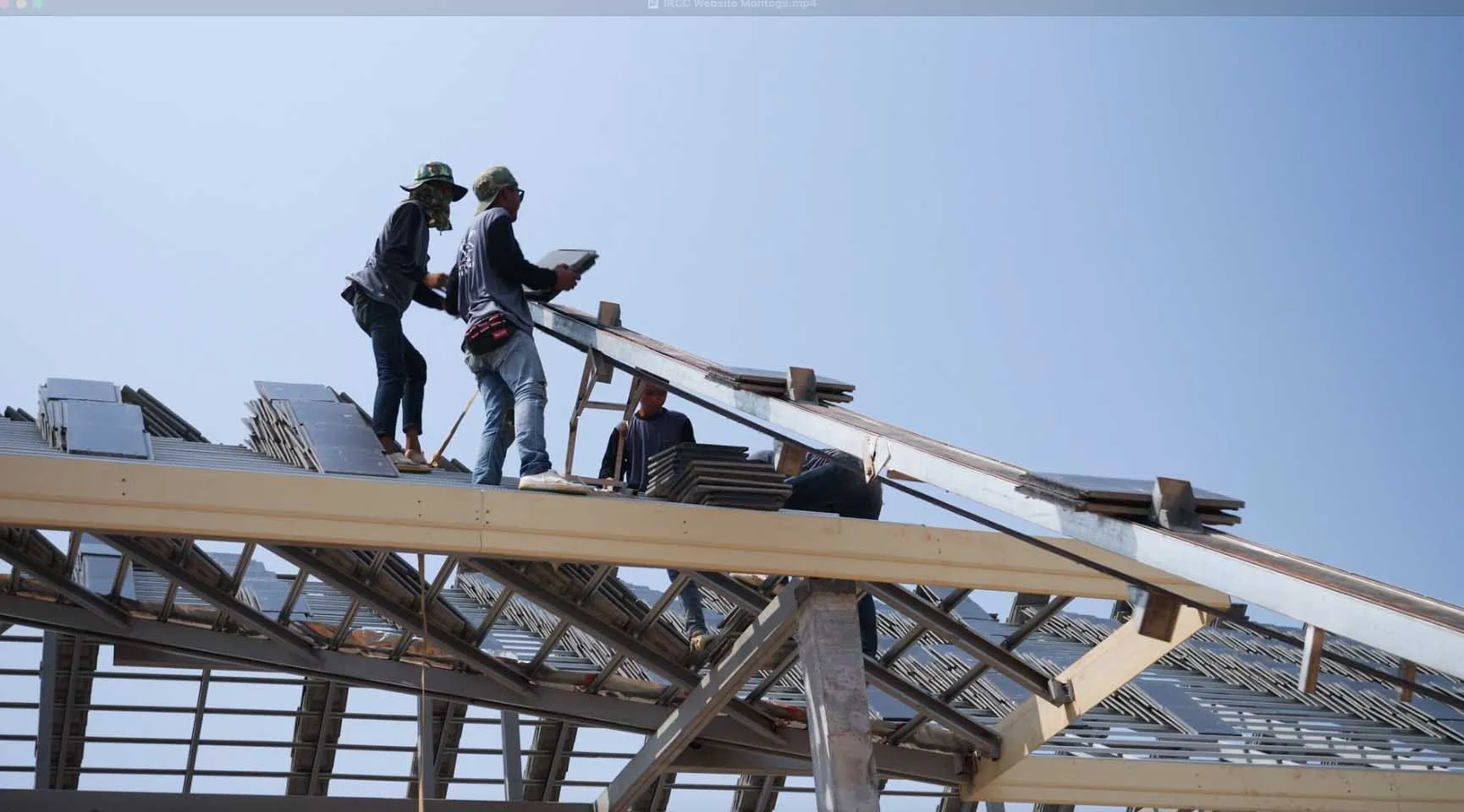 Workers from Scudder Roofing Company installing roofing tiles on a structure in Monterey.