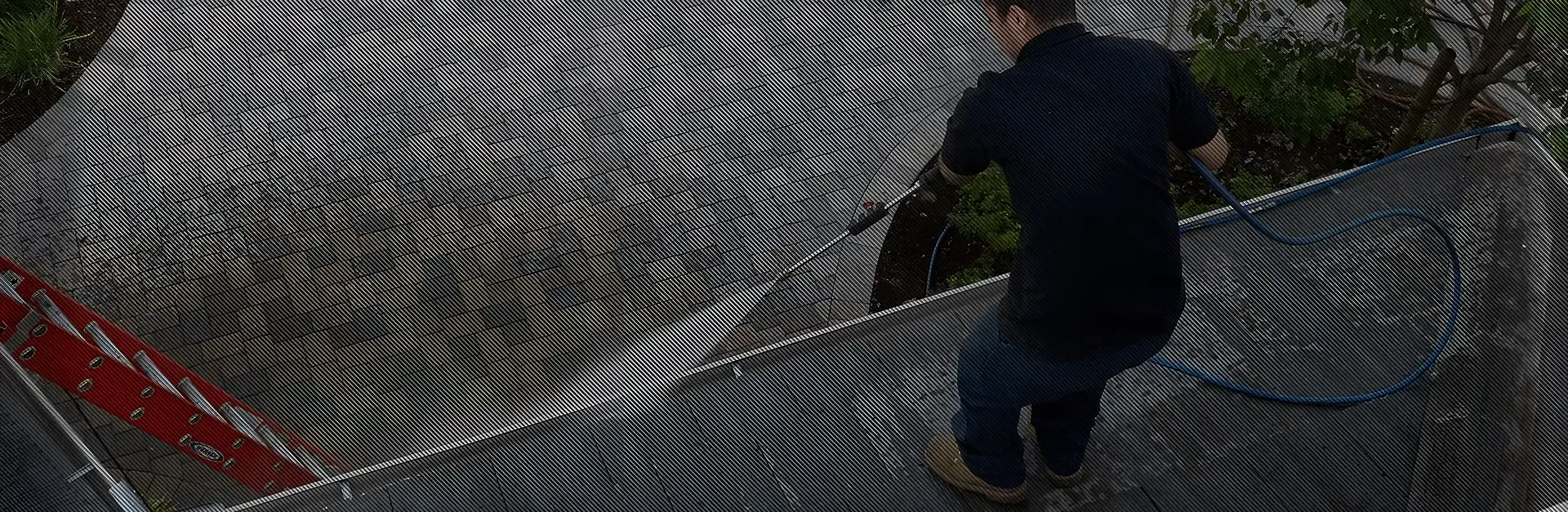A technician from Sierra Roofing & Solar in Dublin performing roof maintenance with a pressure washer.