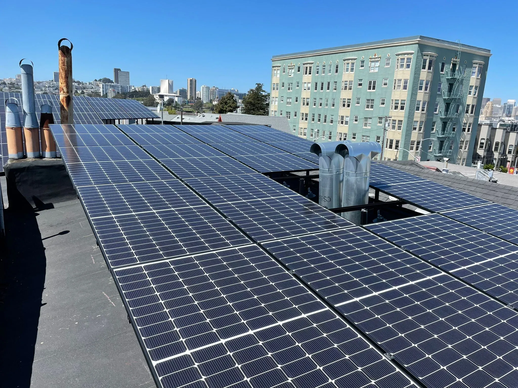 Rooftop solar panels installed by SolarUnion in San Francisco, showcasing solar energy systems with city buildings in the background.