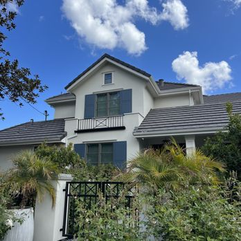A well-maintained house with a tiled roof and lush greenery, showcasing the expert work of South Creek Roofing & Waterproofing Inc. in San Jose.
