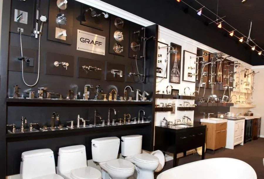 Interior view of a showroom displaying a variety of bathroom fixtures, including faucets, showerheads, and toilets, at SplashWorks in San Jose.