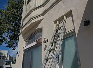 A ladder leaning against a building facade, prepared for painting by Steve Roberts Painting in Walnut Creek.