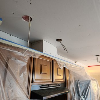 Interior view of a kitchen under renovation, featuring a newly installed ceiling with recessed lighting by Sulvaran Drywall in Antioch.