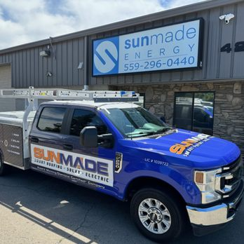 A SunMade Smart Roofing, Solar & Electric branded truck parked in front of a building with the SunMade Energy sign in Fresno.