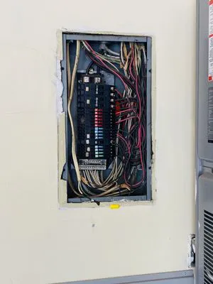 An electrical panel with exposed wiring, showcasing the detailed work by TD West Electric, Inc. in Union City.