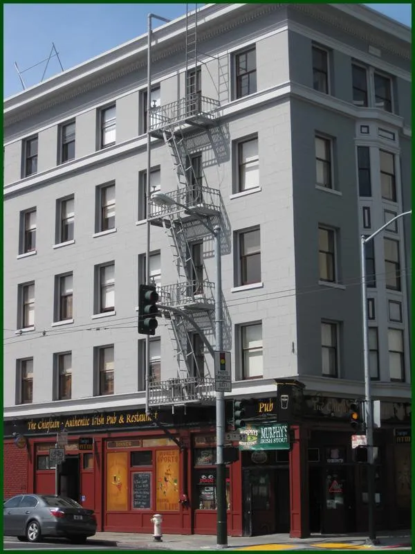"A freshly painted corner building in San Francisco with a pub on the ground floor, showcasing the work of Tara Pro Painting, Inc."