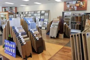 Image of a flooring showroom with various samples of wood and tile flooring on display racks at The Floor Store in Richmond.