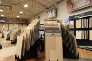 Interior view of a flooring showroom in Richmond, featuring an array of tile and wood samples displayed on racks.