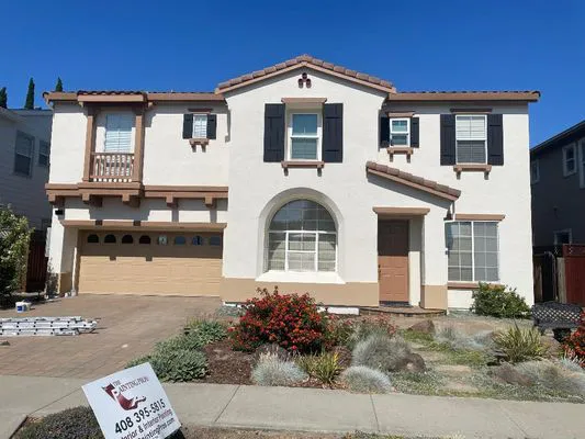 A freshly painted two-story house with a beige exterior and brown accents, showcasing the professional workmanship of The Painting Pros in Los Gatos.