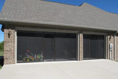 Image of a brick garage with three screened garage doors from Turbo Garage Door in Santa Rosa.