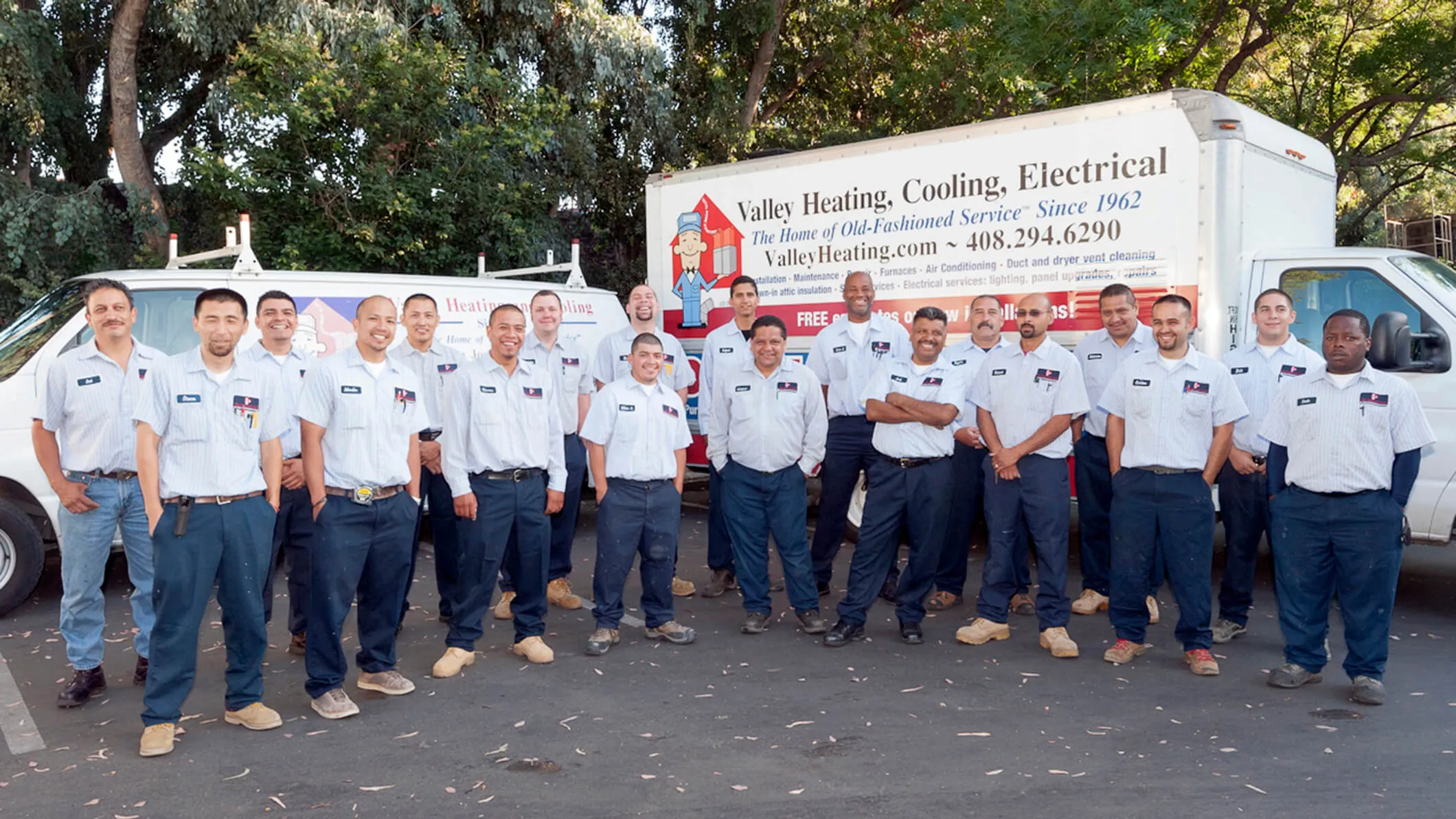 A group of technicians from Valley Heating, Cooling, Electrical and Solar pose in front of their service vehicles in San Jose, dressed in uniform, showcasing their readiness for quality service.