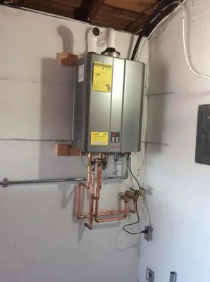 A precision-engineered tankless water heater installed on a wall, representing Water Heaters Masters Inc. in Vacaville.