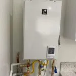 Image of a professionally installed wall-mounted water heater showcasing quality craftsmanship by We Love Small Jobs Handyman Services-Remodelers & Builders in Oakland.