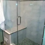 A remodeled shower with a glass enclosure and modern fixtures, showcasing the work of We Love Small Jobs Handyman Services-Remodelers & Builders in Oakland.