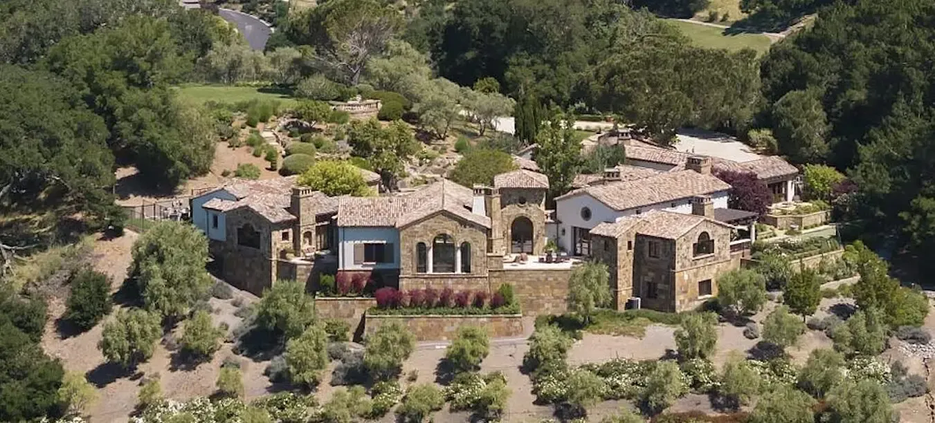 Aerial view of a large, elegant villa surrounded by landscaping and greenery, showcasing WedgeRoofing's craftsmanship in Petaluma.