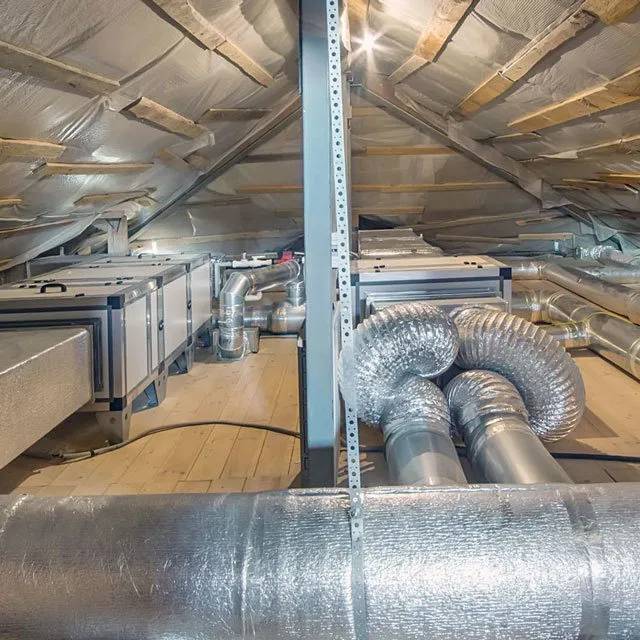 Image of a modern HVAC system installation in an attic, featuring insulated ducts and metal components, performed by Wightons Plumbing, Heating, & Air Conditioning in San Luis Obispo.