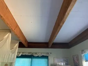 Interior ceiling with wooden beams and blue-lit windows, finished by Wine Country Painters, Inc. in Sebastopol.
