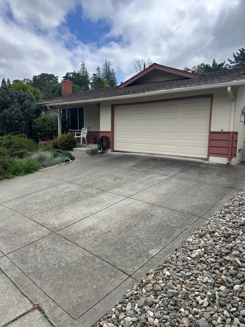A residential home with a large driveway, features a well-maintained roof, exemplifying the quality roofing services provided by Yorkshire Roofing of Northern California Inc. in Livermore.